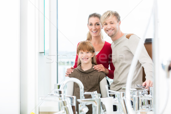 Portrait of a happy family together in the interior of a modern shop Stock photo © Kzenon