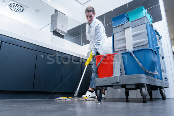 Cleaning lady mopping the floor in restroom Stock photo © Kzenon