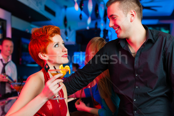 Young couple in bar or club drinking cocktails Stock photo © Kzenon