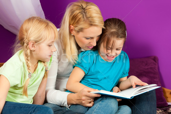 Mother is reading a book Stock photo © Kzenon