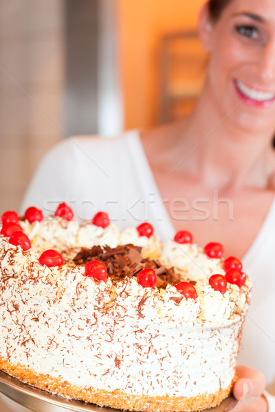 Female baker or pastry chef with torte Stock photo © Kzenon