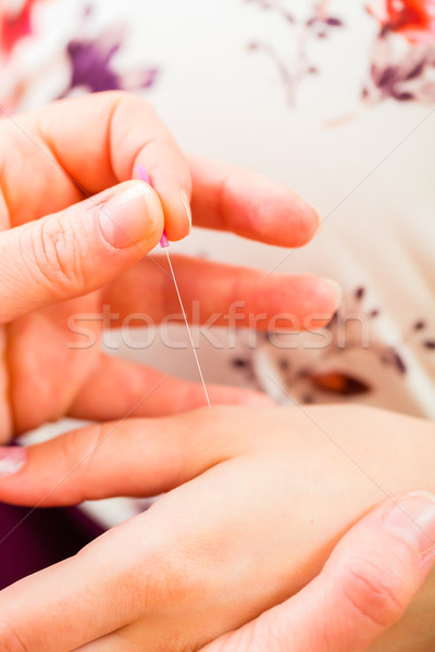 Midwife giving pregnancy acupuncture Stock photo © Kzenon