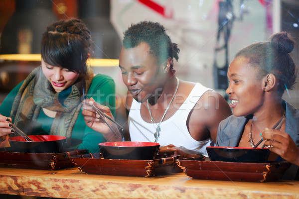 Man and women eating late in Korean eatery Stock photo © Kzenon