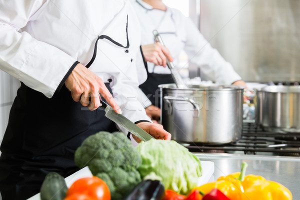 chefs preparing meals in commercial kitchen Stock photo © Kzenon