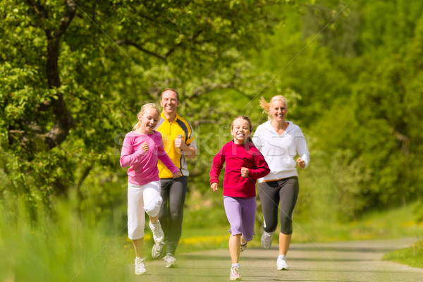 Family jogging for sport outdoors Stock photo © Kzenon