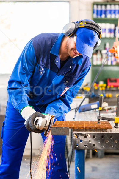 Craftsman sawing with disk grinder Stock photo © Kzenon