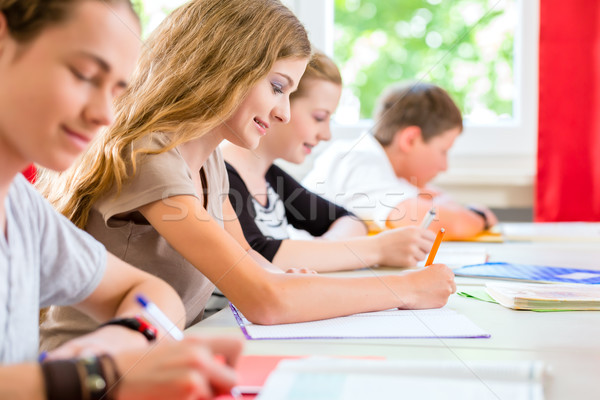 Students writing a test in school concentrating Stock photo © Kzenon
