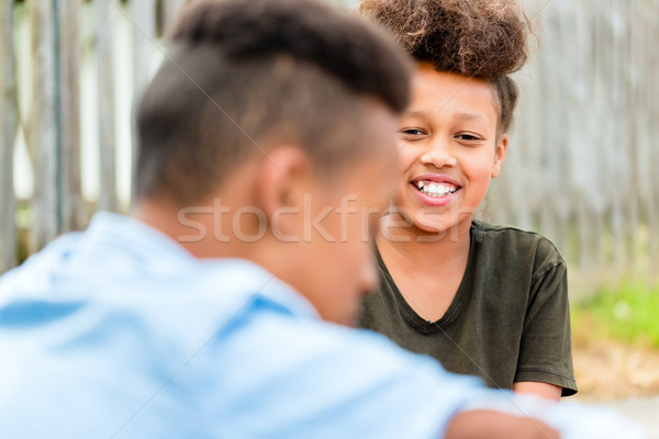 Siblings sitting on floor in yard Stock photo © Kzenon