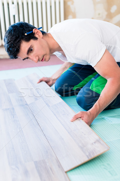 Handyman flooring in home construction site Stock photo © Kzenon