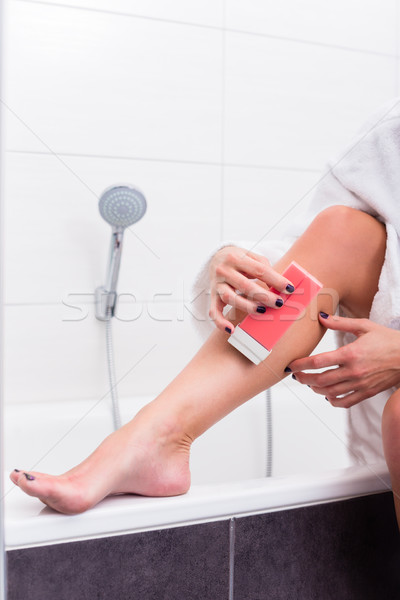 Woman applying epilation lotion on legs Stock photo © Kzenon