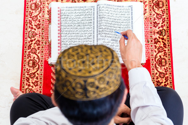 Asian Muslim man studying Koran or Quran Stock photo © Kzenon