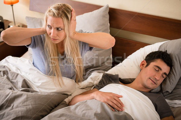 Woman annoyed by the snoring of her partner Stock photo © Kzenon