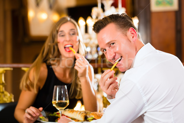 happy couple in restaurant eat fast food Stock photo © Kzenon