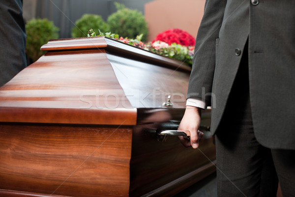 coffin bearer carrying casket at funeral Stock photo © Kzenon