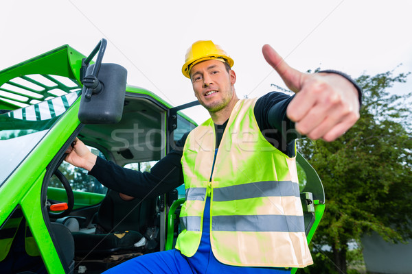 Builder in front of  construction machinery Stock photo © Kzenon