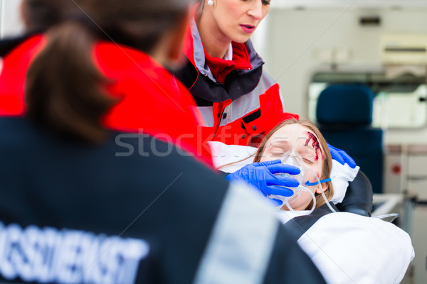 Ambulance helping injured woman on stretcher Stock photo © Kzenon