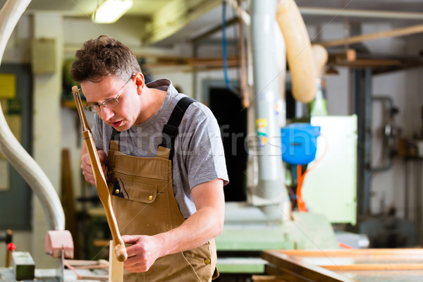 Carpenter using hand saw Stock photo © Kzenon