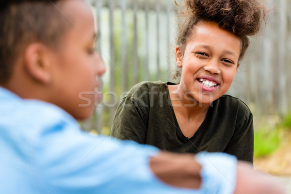 Siblings sitting on floor in yard Stock photo © Kzenon