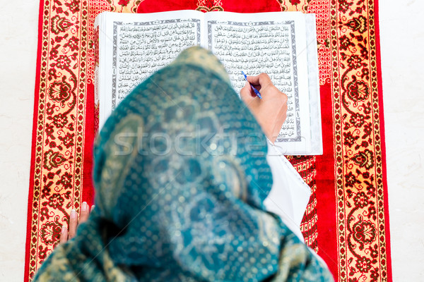Asian Muslim woman studying Koran or Quran Stock photo © Kzenon