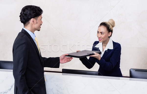 Applicant giving his documents to receptionist Stock photo © Kzenon