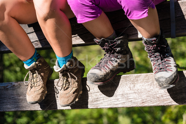 Two children with hiking boots sitting on rail of bridge  Stock photo © Kzenon