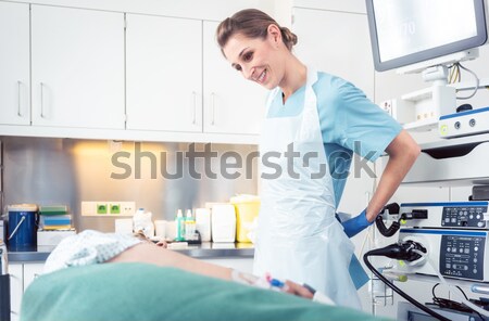 Stock photo: Blood giver looking at nurse taking blood from donor