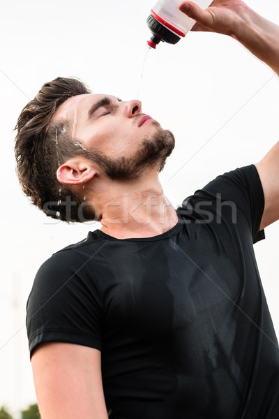 Man drinking from water bottle during sports Stock photo © Kzenon