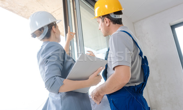 Stock photo: Architect and construction worker checking windows on site