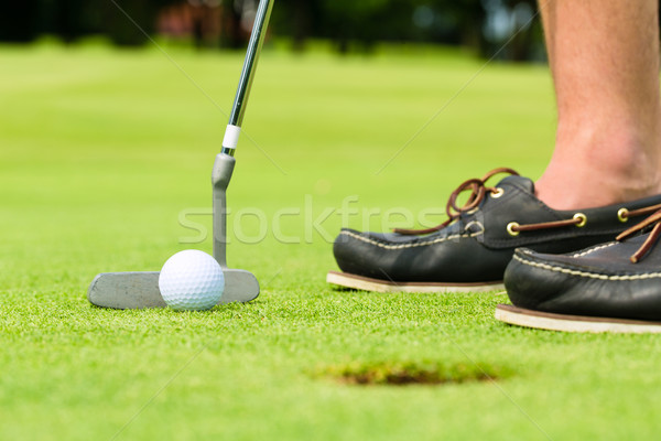 Golf player putting ball in hole Stock photo © Kzenon