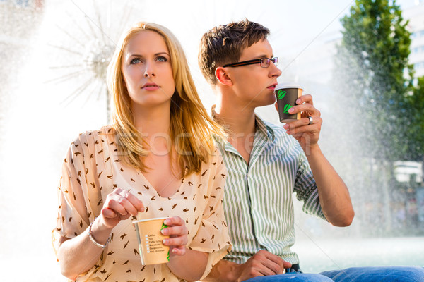 Stock photo: Couple enjoying take away coffee in a break