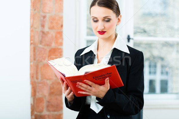 Lawyer in office reading law book Stock photo © Kzenon