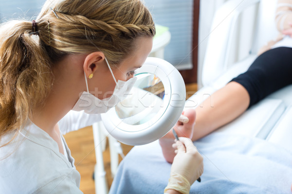 Woman in poidatry studio receiving pedicure Stock photo © Kzenon