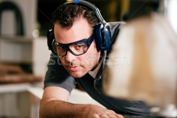 Carpenter using electric saw Stock photo © Kzenon