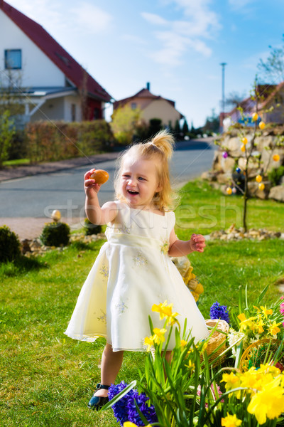 Girl on Easter egg hunt with eggs Stock photo © Kzenon