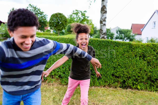 Siblings playing in garden Stock photo © Kzenon