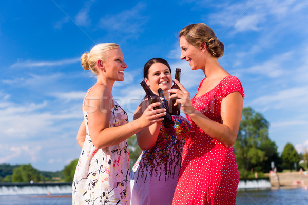 Stock photo: Friends clinking and saying Cheers at river beach
