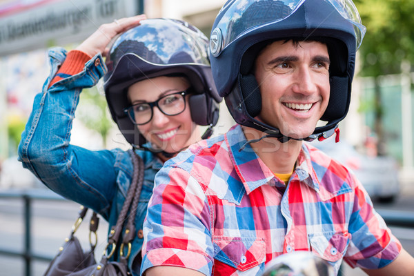 Stock photo: Girl with glasses sitting on pillion seat of scooter