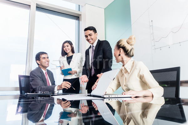 Group of businesswomen and businessmen negotiate contract Stock photo © Kzenon