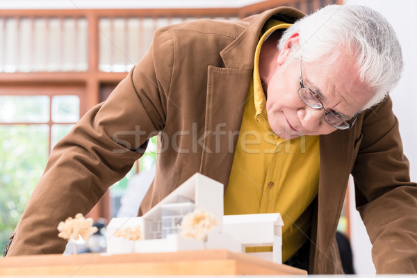 Senior architect working on the project of a modern building Stock photo © Kzenon