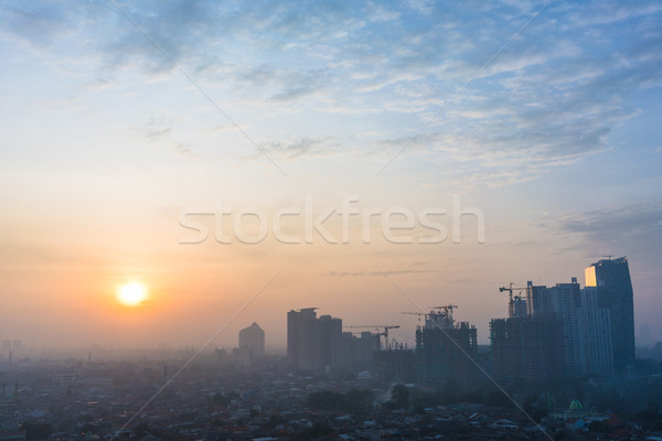 Panorámakép kilátás Dzsakarta városkép napfelkelte felhőkarcolók Stock fotó © Kzenon