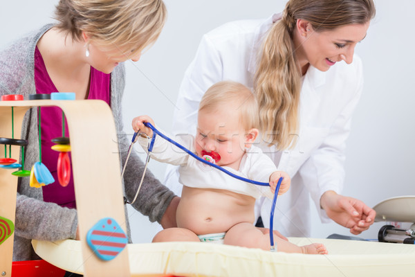 Stock photo: Cute and healthy baby girl playing with the stethoscope during routine check-up