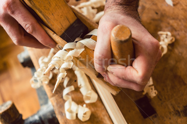 Top view on master carpenter working with wood planer Stock photo © Kzenon