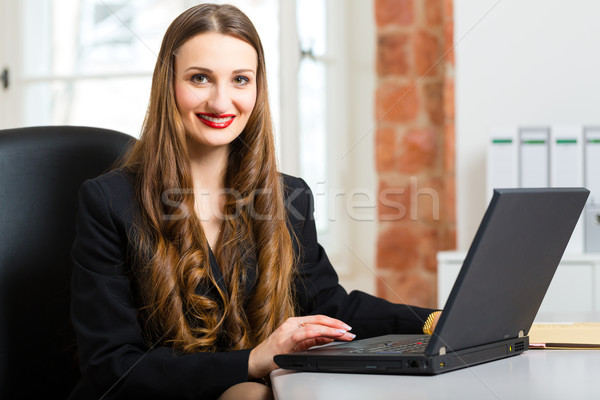 woman in office sitting on the computer Stock photo © Kzenon