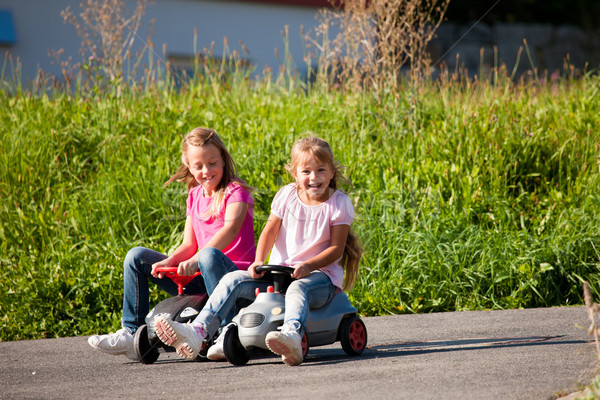 Two sisters with toy cars Stock photo © Kzenon
