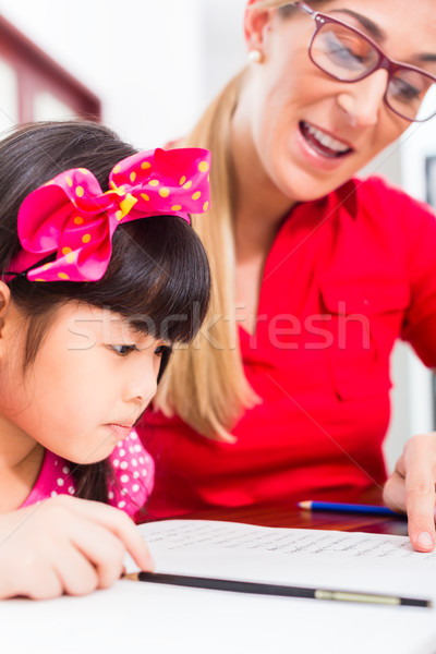 English private teacher working with Asian girl  Stock photo © Kzenon