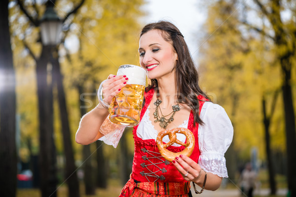 Girl in traditional bavarian Tracht drinking beer out of huge mu Stock photo © Kzenon