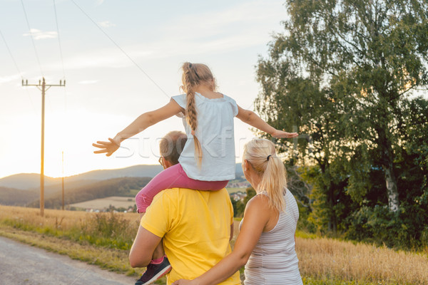 Stock photo: Family carrying child piggyback on summer walk