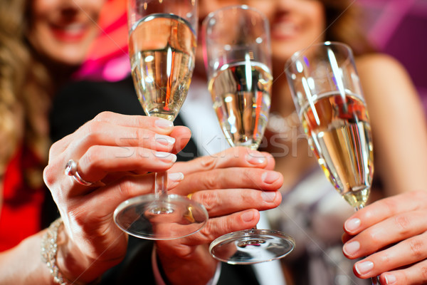 Stock photo: People with champagner in a bar