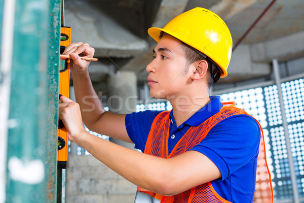 Builder or worker controlling building or construction site Stock photo © Kzenon