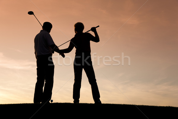 Senior couple playing Golf at sunset Stock photo © Kzenon